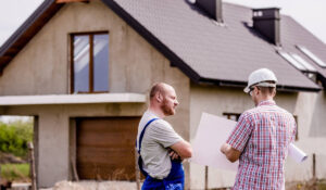 Planning with the contractor in front of a house