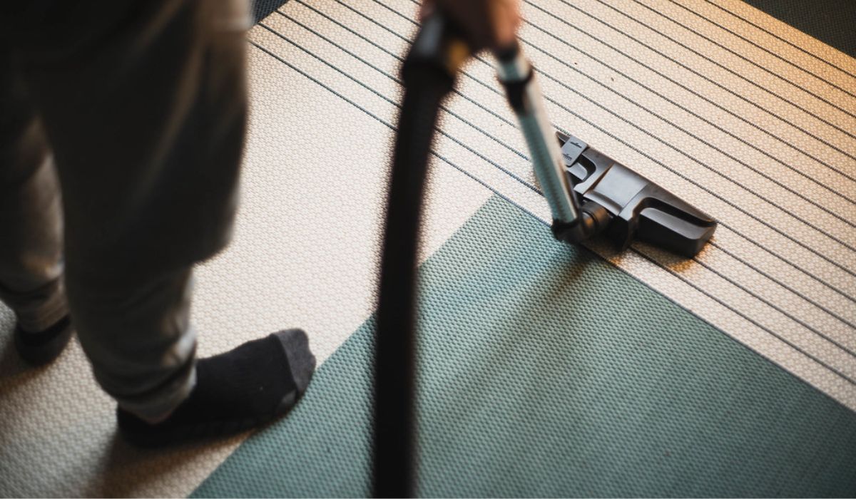 a professional vacuuming the carpet
