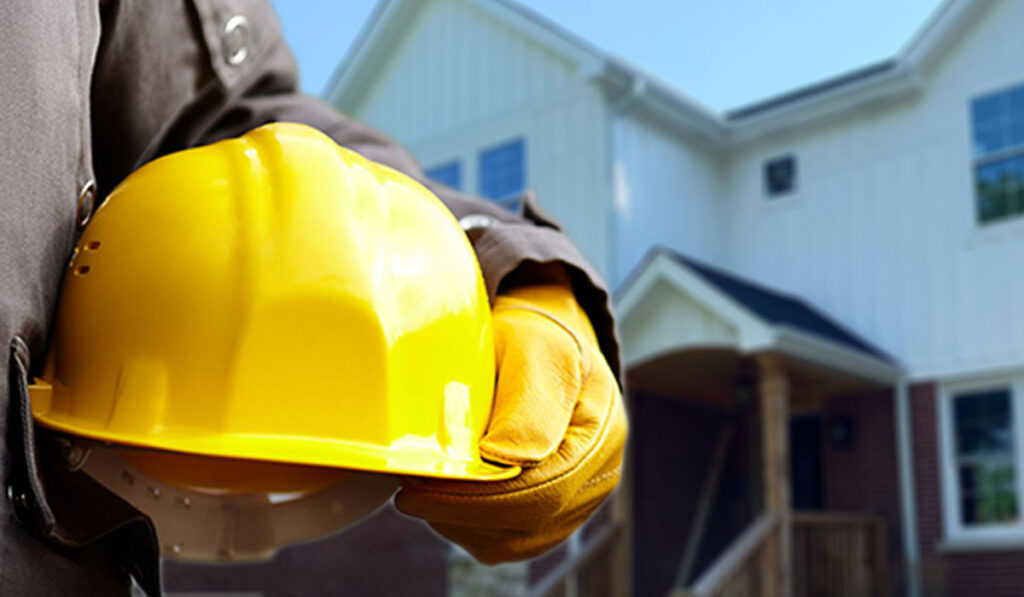 a man holding a yellow hard hat